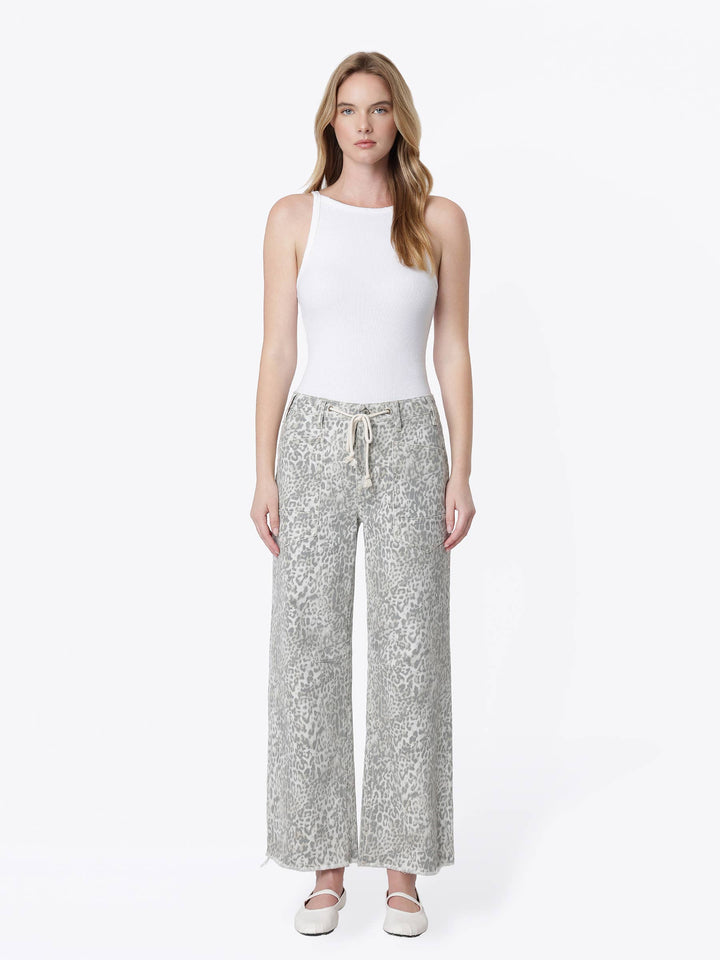 Neutral gray and cream leopard print wide-leg jeans with a high-rise drawstring waist, oversized front patch pockets, ankle length, and raw hem.