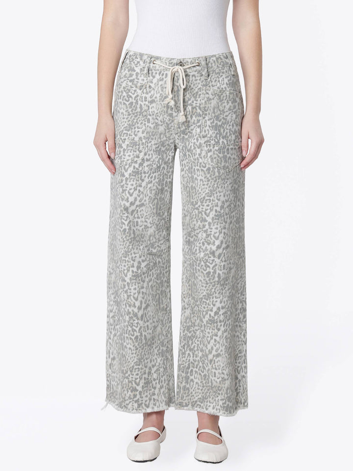 Neutral gray and cream leopard print wide-leg jeans with a high-rise drawstring waist, oversized front patch pockets, ankle length, and raw hem.